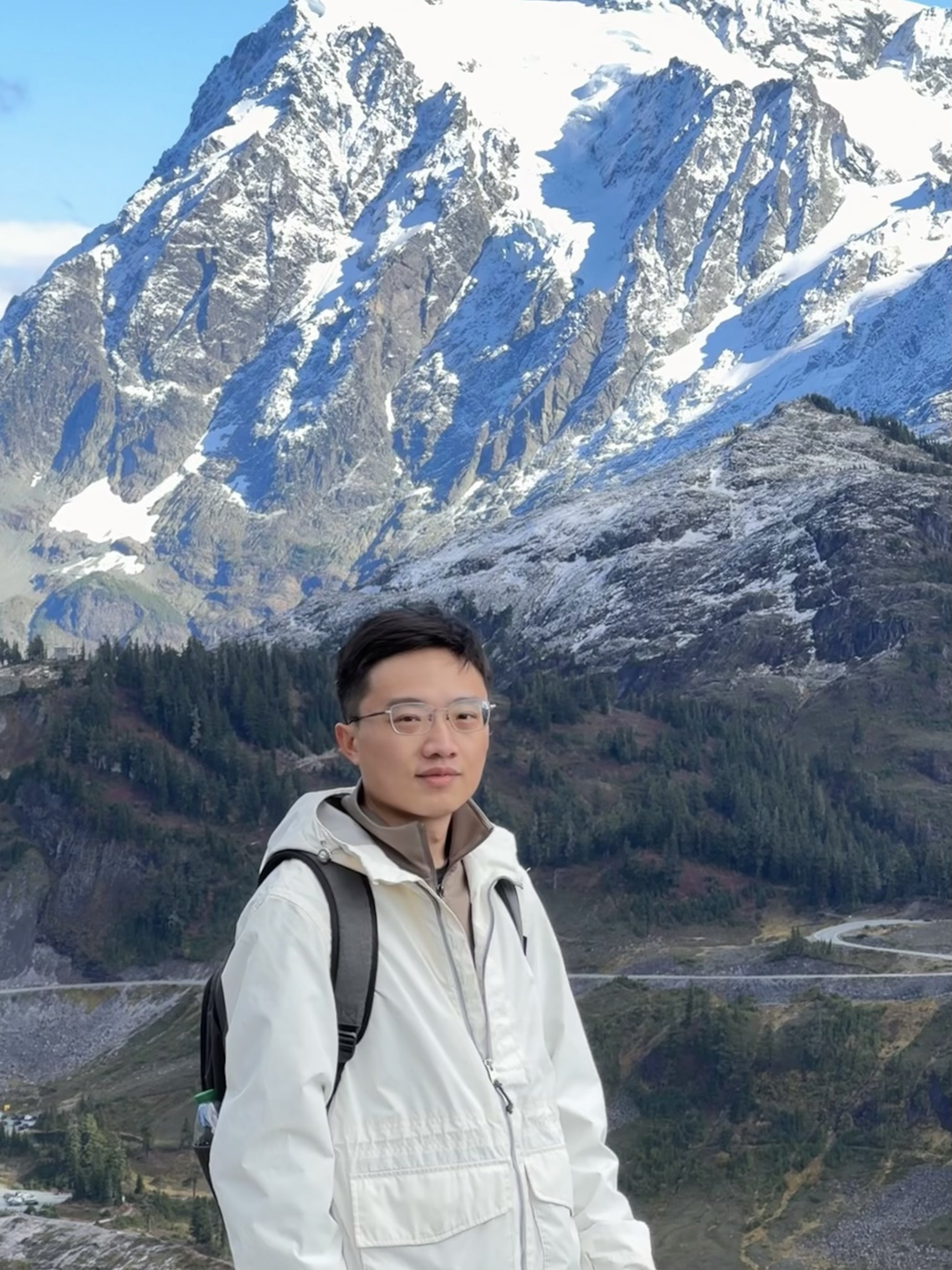 Zifeng Wang in front of snow-covered mountains